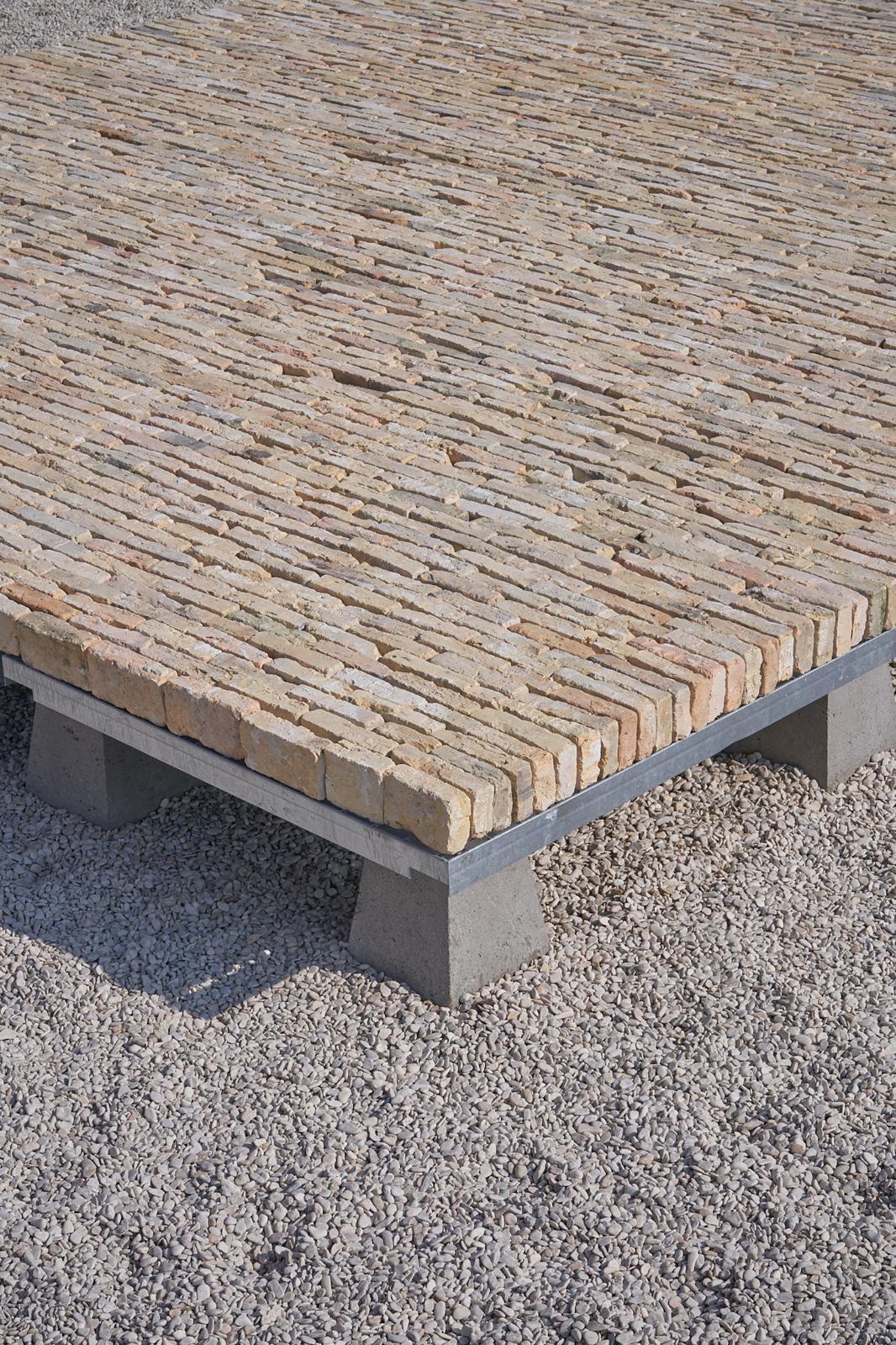 REST — 2025 — Layered construction of foundation blocks , galvanized metal grids and bricks — Mirns — by Sander Wassink — photo Pieter Maes